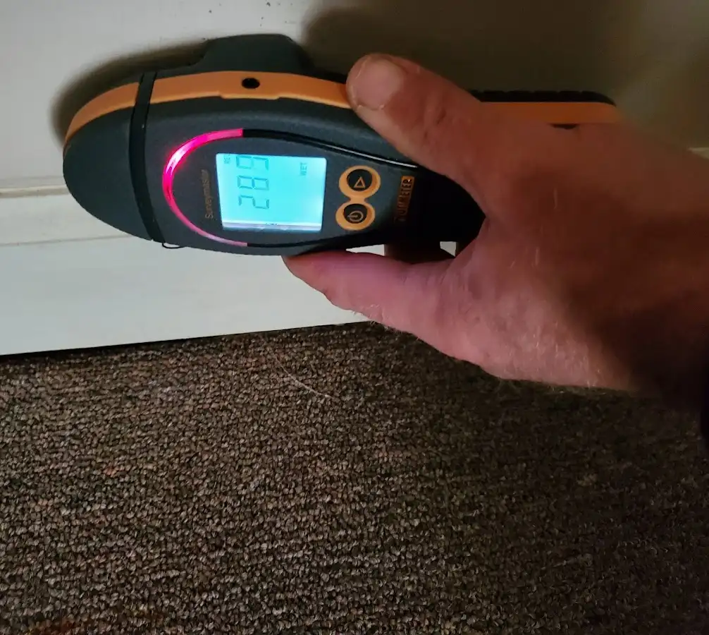Moisture detection at baseboard during Storm Damage Restoration in Covedale